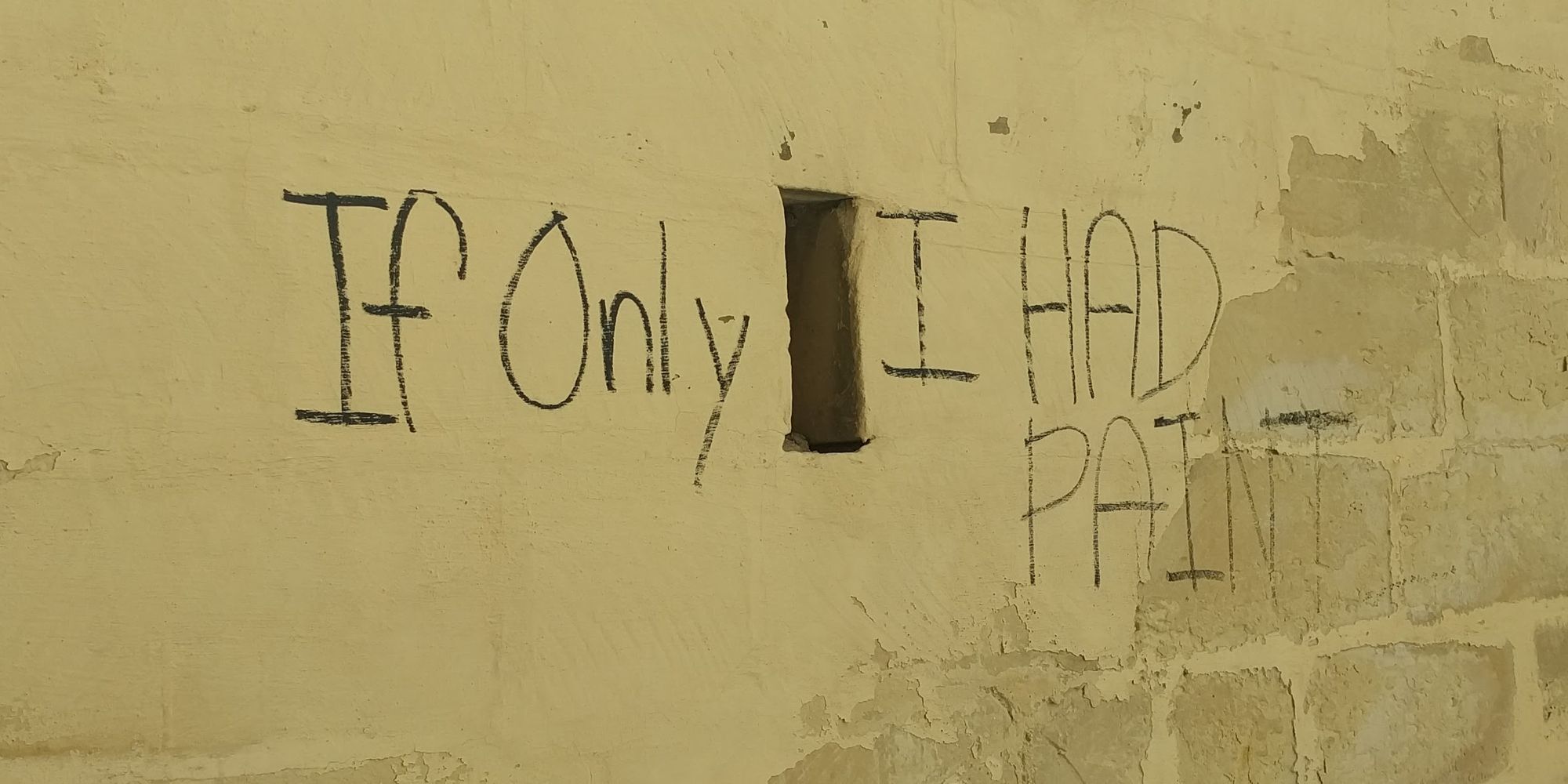 Wall in Malta displaying the words: If only I had paint